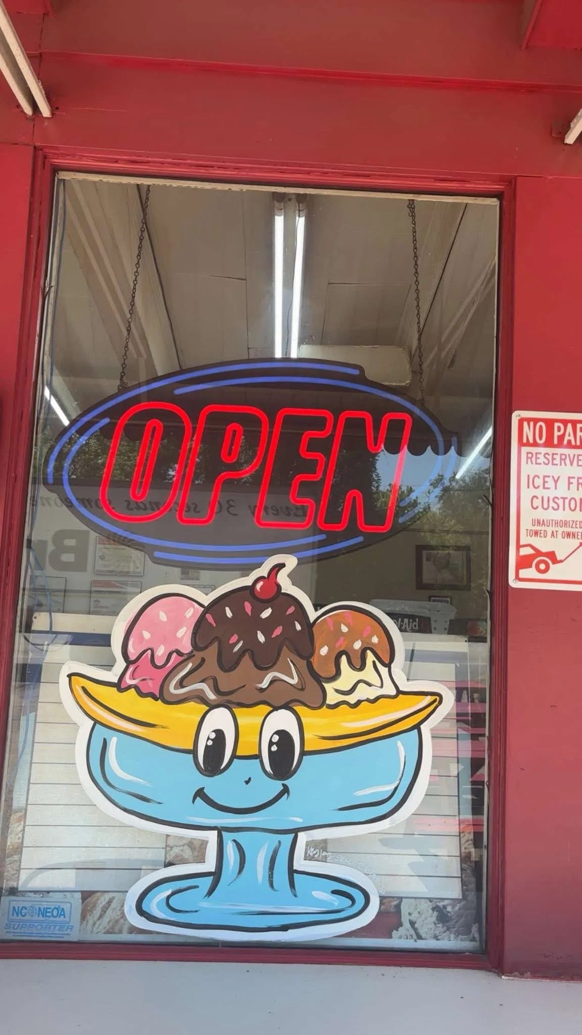 Icey Freeze window with an open sign and banana split artwork